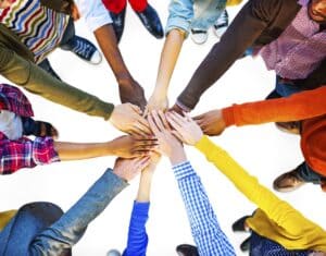 Employees in circle with hands together